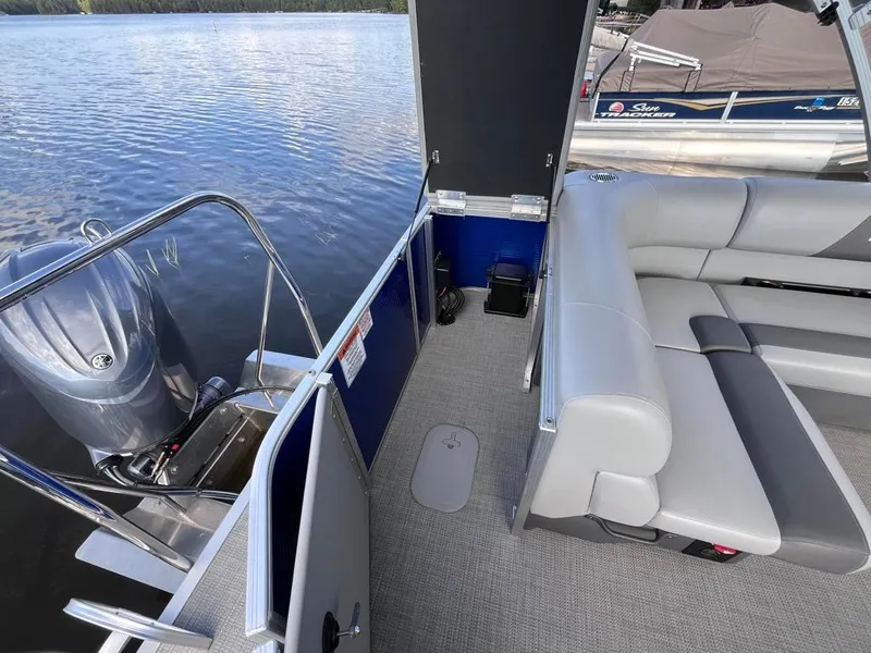Slide: The Image of 2024 Bennington 22SVL-SPS pontoon boat interior with seating and outboard motor. - 36