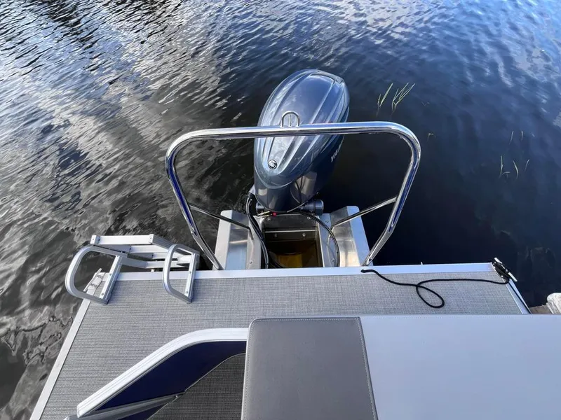 Slide: The Image of 2024 Bennington 22SVL-SPS boat with outboard motor and swim ladder on water. - 37