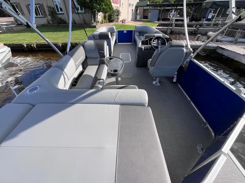 Slide: The Image of 2024 Bennington 22SVL-SPS pontoon boat interior with gray seating and steering console. - 38