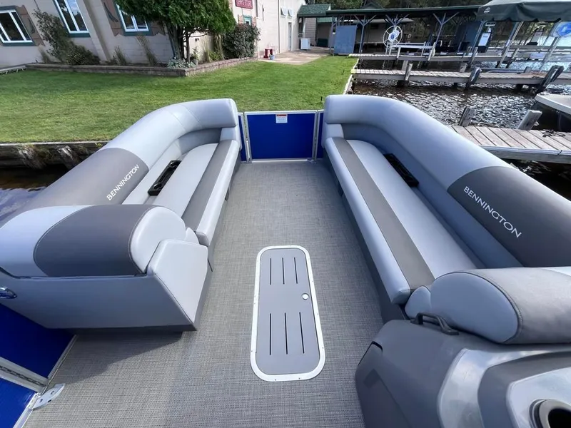 Slide: The Image of 2024 Bennington 22SVL-SPS pontoon boat interior with gray seating and spacious layout. - 7