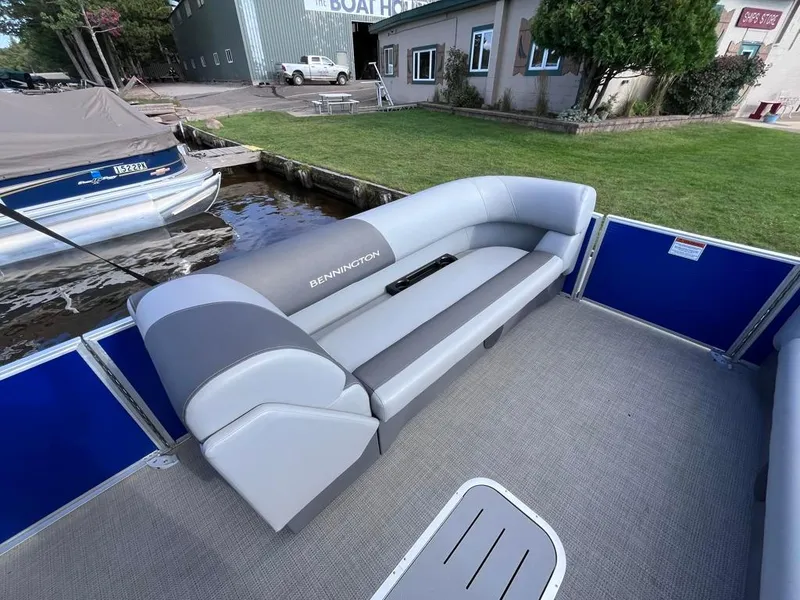 Slide: The Image of 2024 Bennington 22SVL-SPS pontoon boat interior with gray seating and blue accents. - 8