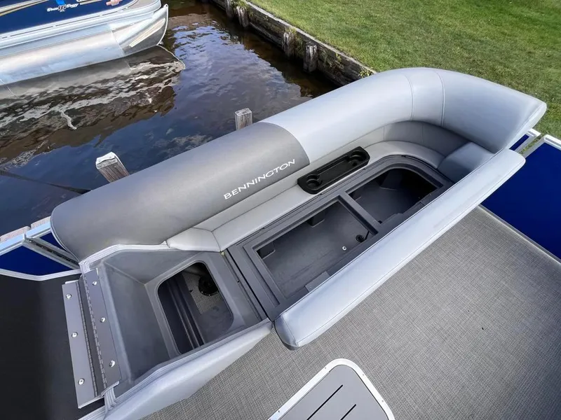 Slide: The Image of 2024 Bennington 22SVL-SPS pontoon boat with open storage compartment. - 9