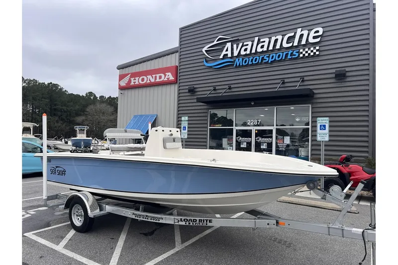 Slide: The Image of 2024 Carolina Skiff EV180 Sea Skiff on trailer at Avalanche Motorsports dealership. - 1