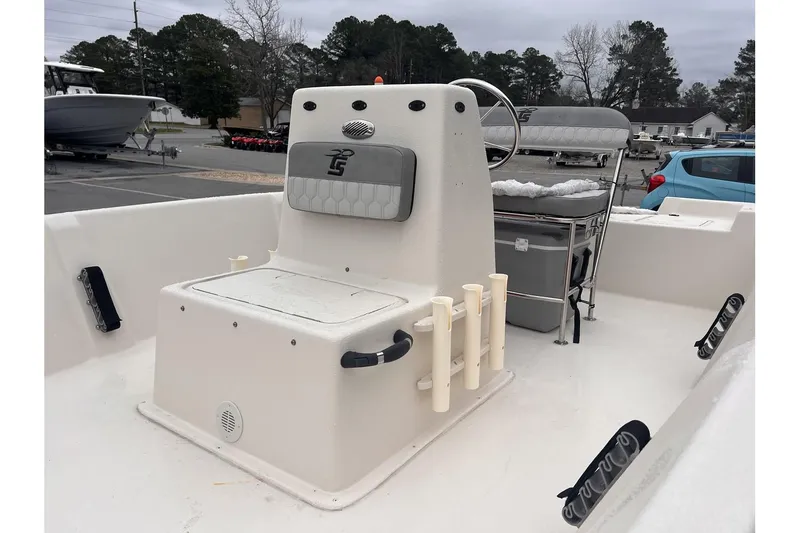 Slide: The Image of 2024 Carolina Skiff EV180 Sea Skiff boat interior with seating and rod holders. - 11