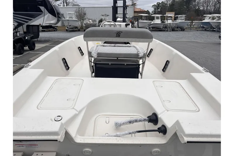 Slide: The Image of 2024 Carolina Skiff EV180 Sea Skiff boat interior, featuring seating and storage compartments. - 4