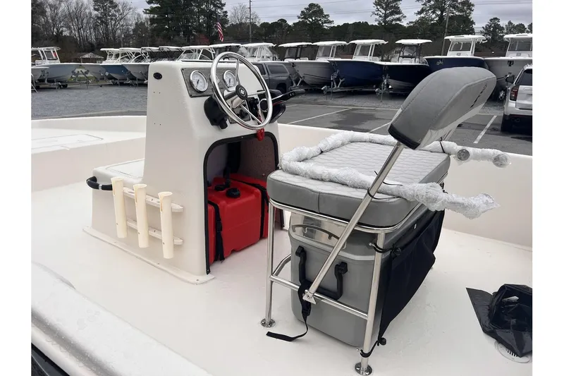 Slide: The Image of 2024 Carolina Skiff EV180 Sea Skiff boat interior with steering console and seating. - 9