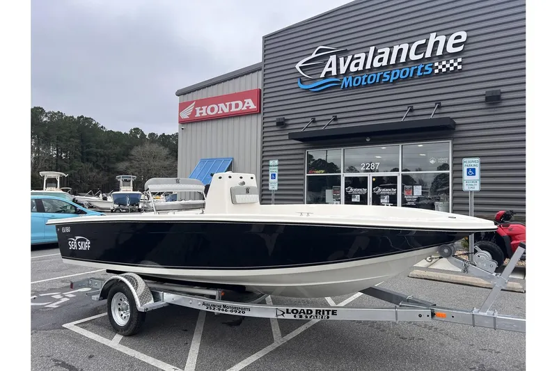The Image of 2024 Carolina Skiff EV180 boat on trailer at Avalanche Motorsports dealership. - 1