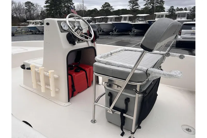 Slide: The Image of 2024 Carolina Skiff EV180 boat interior with console, seating, and storage. - 5