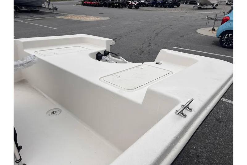 Slide: The Image of 2024 Carolina Skiff EV180 boat deck in a parking lot. - 6