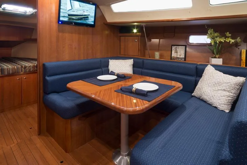Slide: The Image of Interior of 2016 Marlow-Hunter 37 sailboat with dining area and blue seating. - 10