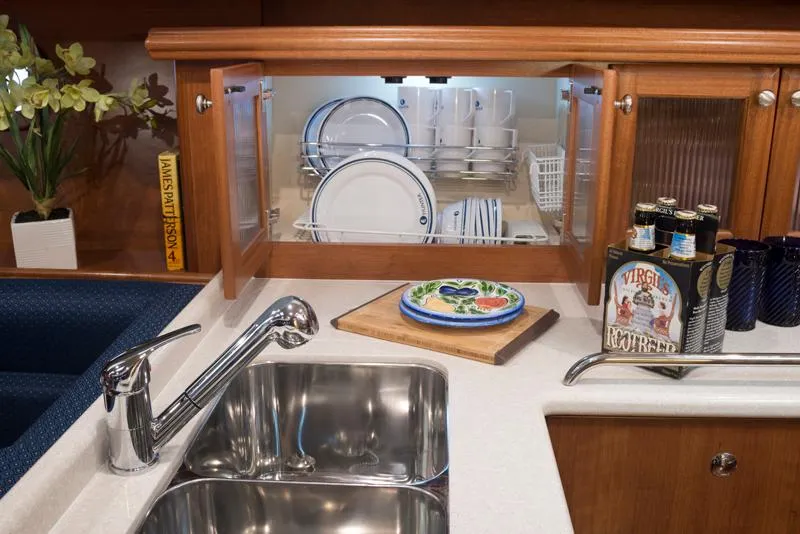 Slide: The Image of Modern galley kitchen in 2016 Marlow-Hunter 37 yacht with sink, dish rack, and decor. - 11