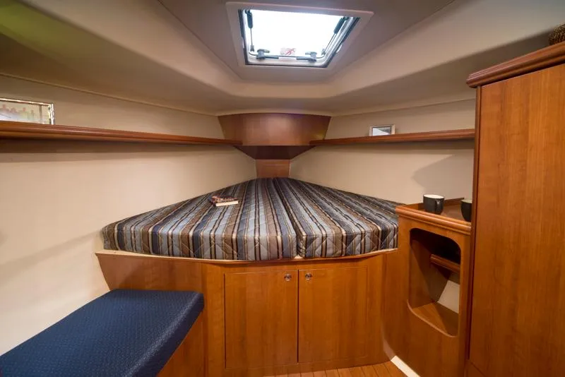Slide: The Image of 2016 Marlow-Hunter 37 interior cabin with bed and storage. - 13