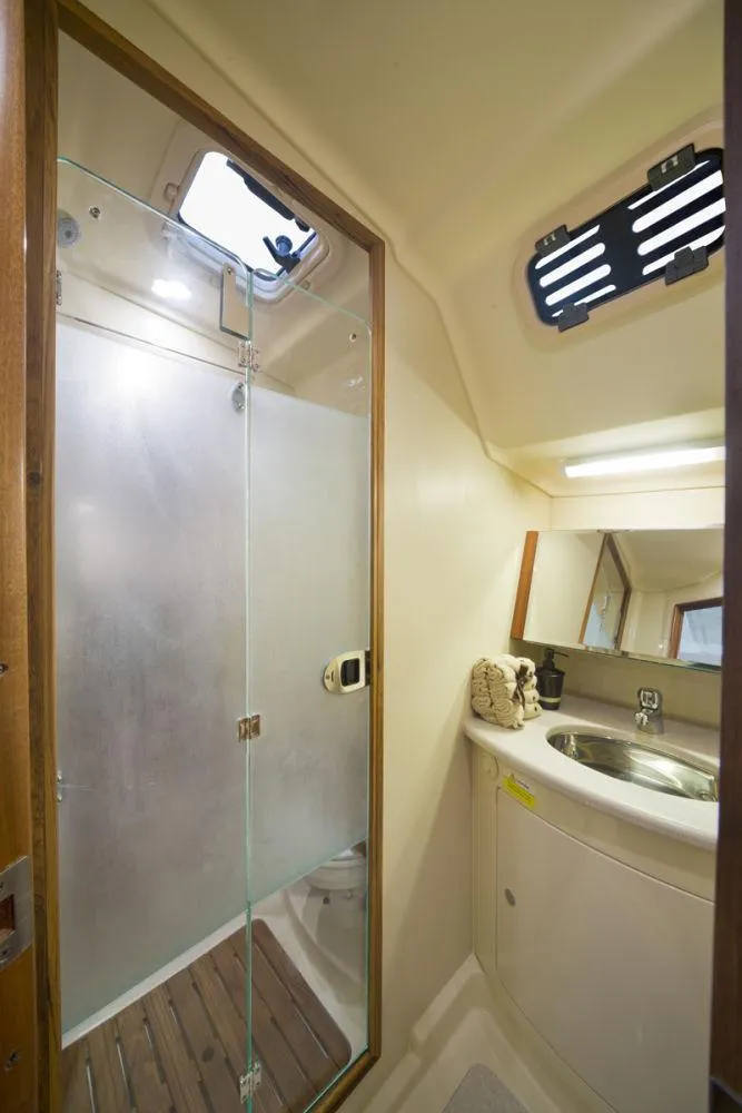 Slide: The Image of 2016 Marlow-Hunter 37 yacht bathroom with glass shower and sink. - 15