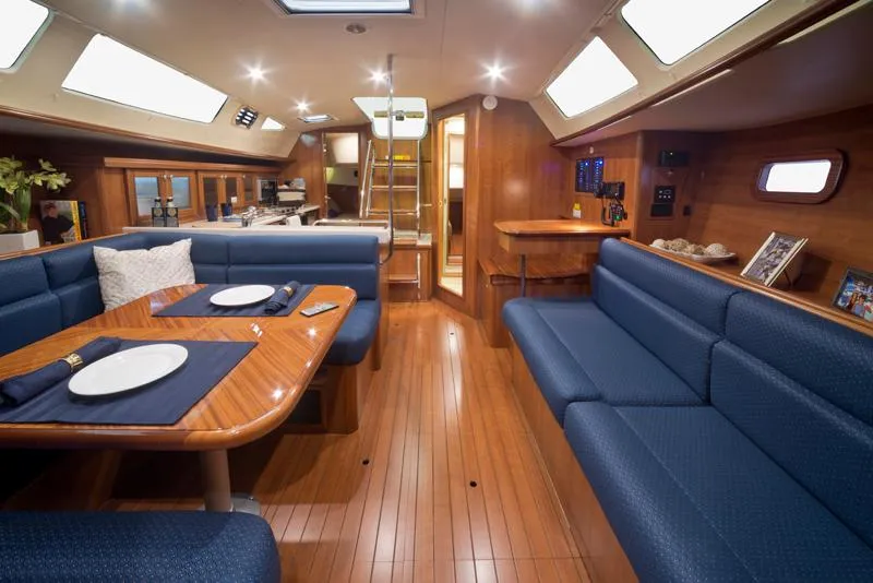 Slide: The Image of Interior of 2016 Marlow-Hunter 37 sailboat with blue seating and wooden finishes. - 17