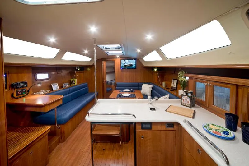 Slide: The Image of Interior of 2016 Marlow-Hunter 37 sailboat with modern kitchen and cozy seating area. - 18