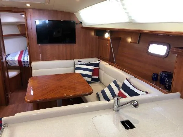 Slide: The Image of Interior of 2016 Marlow-Hunter 37 sailboat with dining area and modern kitchen. - 3