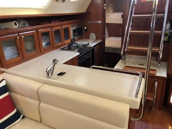 Slide: The Image of 2016 Marlow-Hunter 37 yacht interior with modern kitchen and cozy seating area. - 5