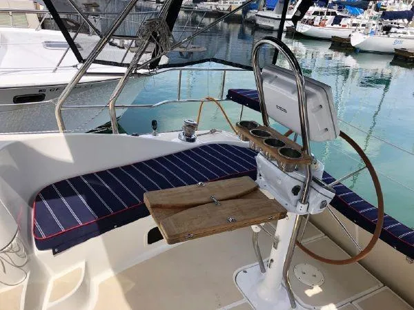 Slide: The Image of Cockpit of 2016 Marlow-Hunter 37 sailboat with striped seating and wooden helm station. - 6