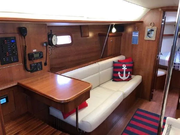 Slide: The Image of 2016 Marlow-Hunter 37 yacht interior with wooden finish and white seating. - 8