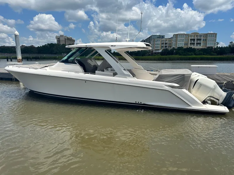 The Image of 2019 Tiara Sport 38 LS boat docked on a sunny day with buildings in the background. - 0