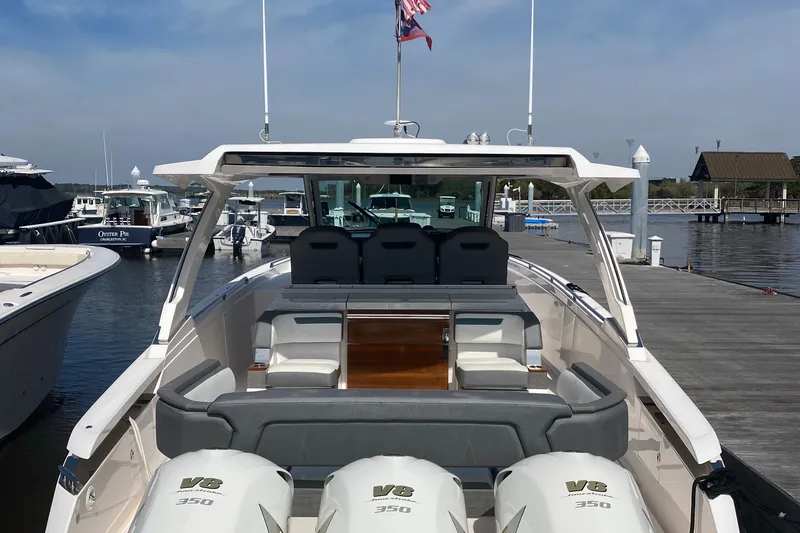 Slide: The Image of 2019 Tiara Sport 38 LS boat docked, featuring triple Yamaha 350 engines. - 10