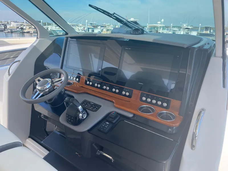 Slide: The Image of 2019 Tiara Sport 38 LS boat helm with modern controls and navigation screens. - 16