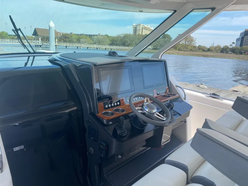 Slide: The Image of 2019 Tiara Sport 38 LS boat helm with dual screens and steering wheel. - 18
