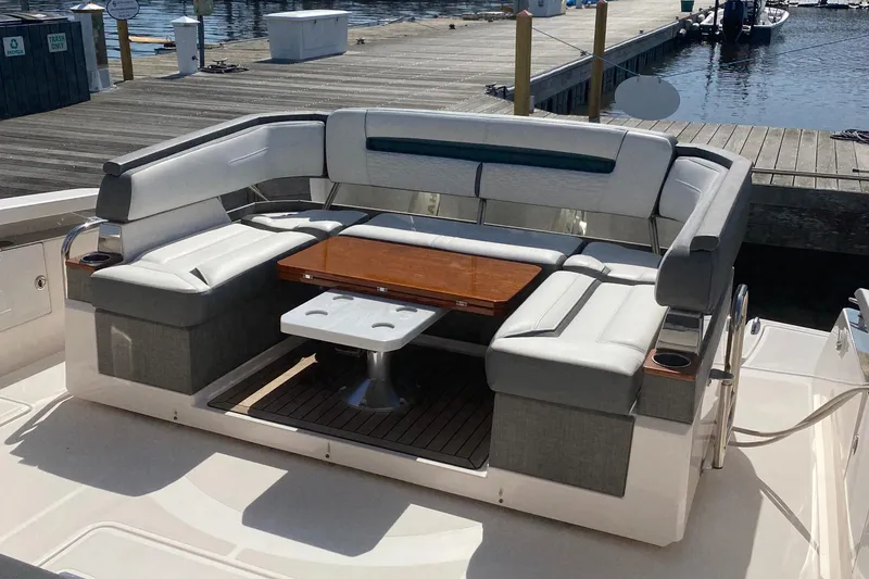 Slide: The Image of 2019 Tiara Sport 38 LS boat with spacious seating and table at the dock. - 21