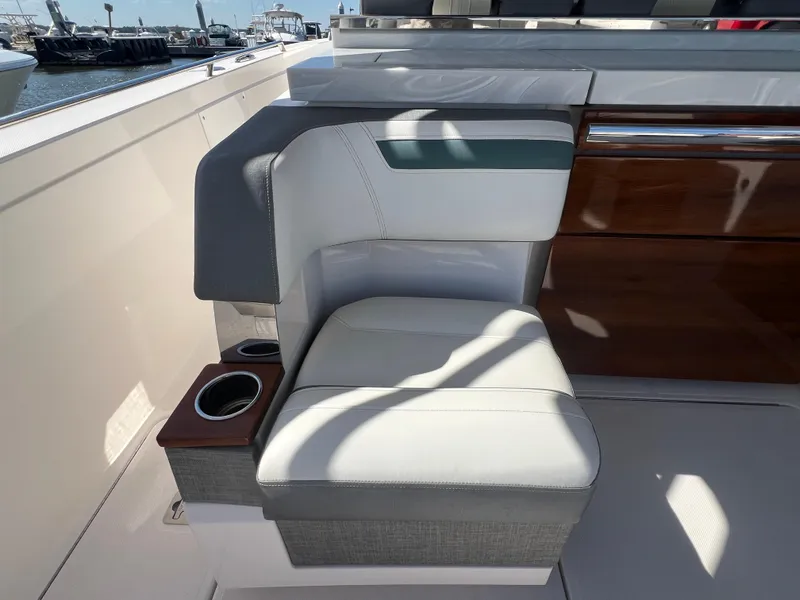 Slide: The Image of 2019 Tiara Sport 38 LS boat interior with cushioned seating and cup holders. - 23