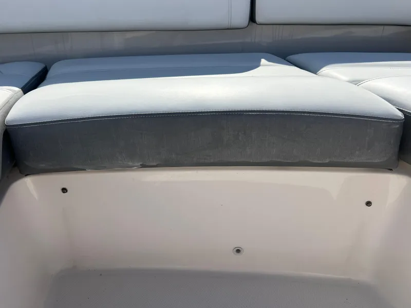 Slide: The Image of 2019 Tiara Sport 38 LS boat seating area with gray cushions. - 25