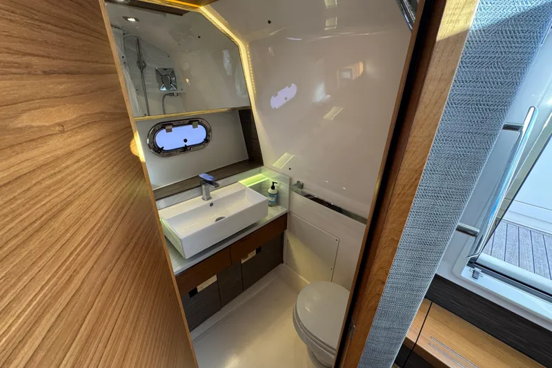 Slide: The Image of Luxurious bathroom interior of 2019 Tiara Sport 38 LS yacht with modern sink and porthole. - 26