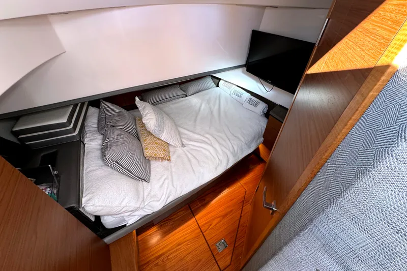 Slide: The Image of Luxurious cabin interior of 2019 Tiara Sport 38 LS with cozy bedding and modern design. - 28