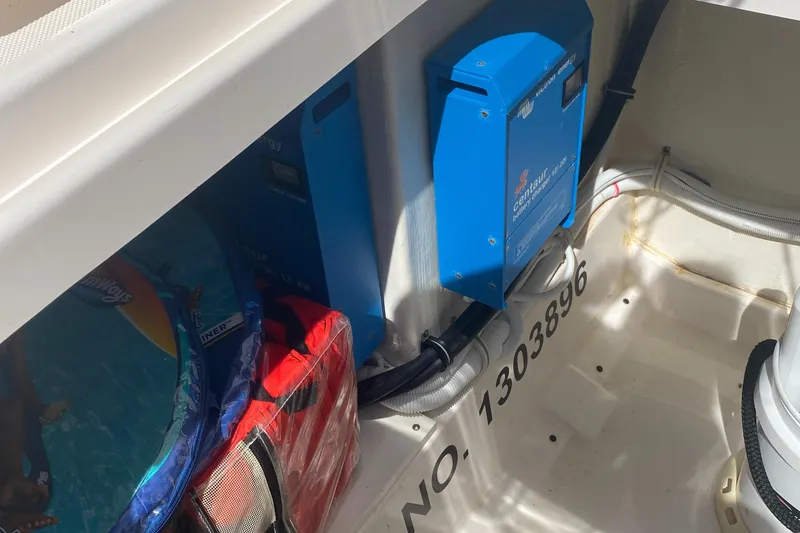 Slide: The Image of 2019 Tiara Sport 38 LS boat storage compartment with equipment and life jackets. - 29