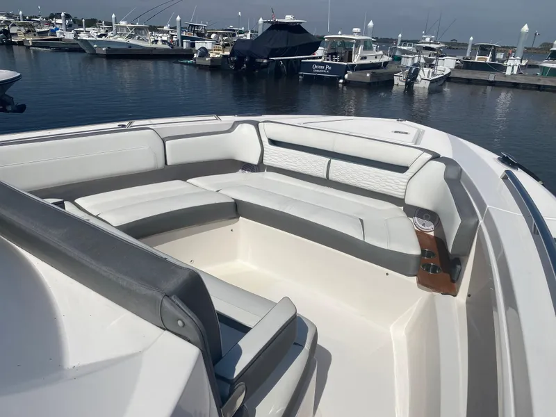 Slide: The Image of 2019 Tiara Sport 38 LS boat with spacious seating at a marina. - 5