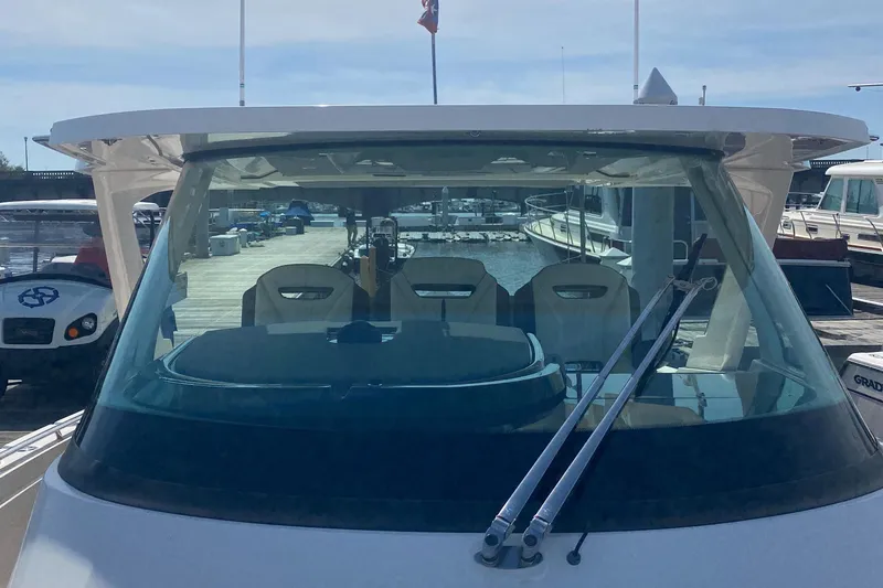 Slide: The Image of 2019 Tiara Sport 38 LS boat docked at a marina, front view. - 6