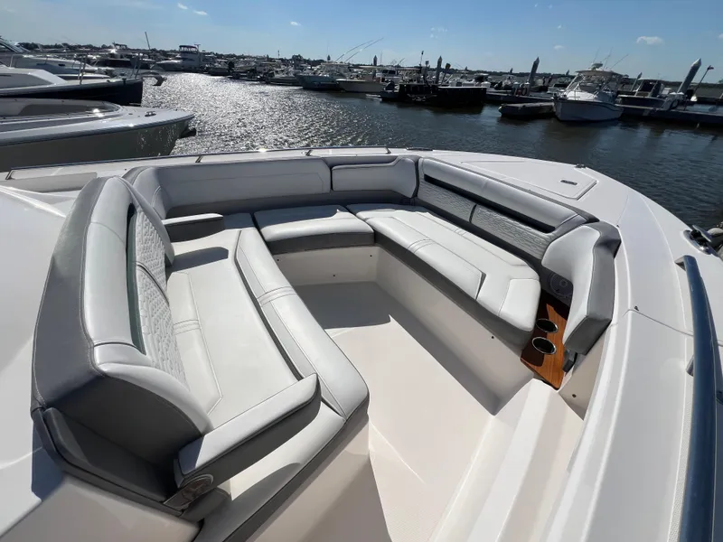 Slide: The Image of Luxurious seating area on a 2019 Tiara Sport 38 LS boat, docked at a marina. - 7