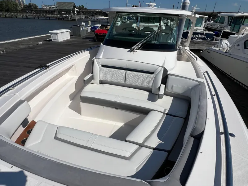Slide: The Image of 2019 Tiara Sport 38 LS boat with spacious seating at a marina dock. - 8