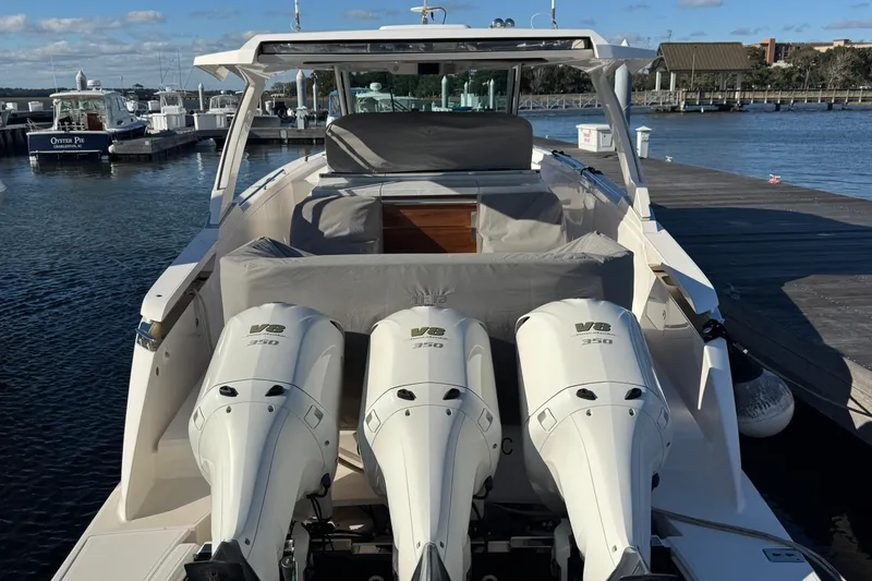 Slide: The Image of 2019 Tiara Sport 38 LS boat with triple V8 engines docked at marina. - 9