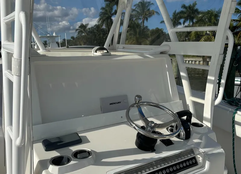 Slide: The Image of 2018 Invincible 39 Open Fisherman boat helm with steering wheel and controls. - 11