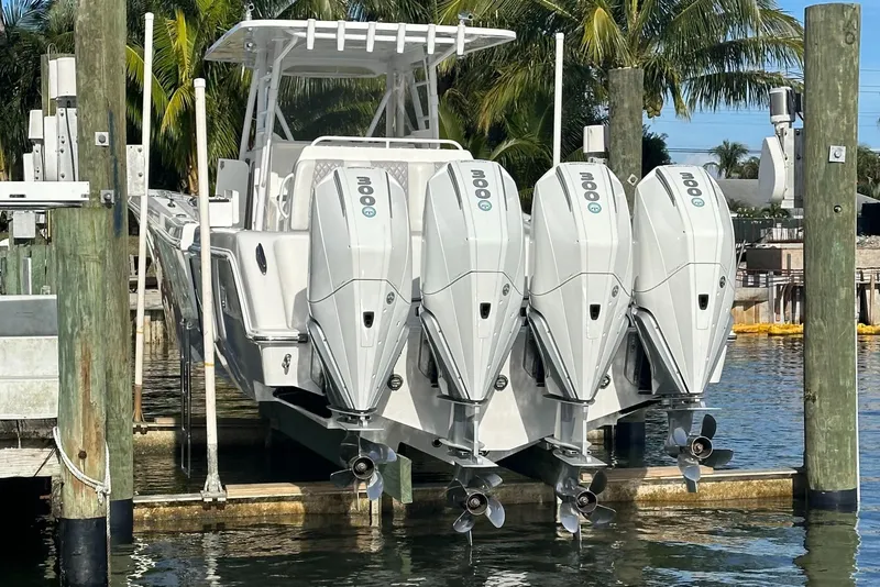 Slide: The Image of 2018 Invincible 39 Open Fisherman with four powerful outboard engines docked by palm trees. - 5
