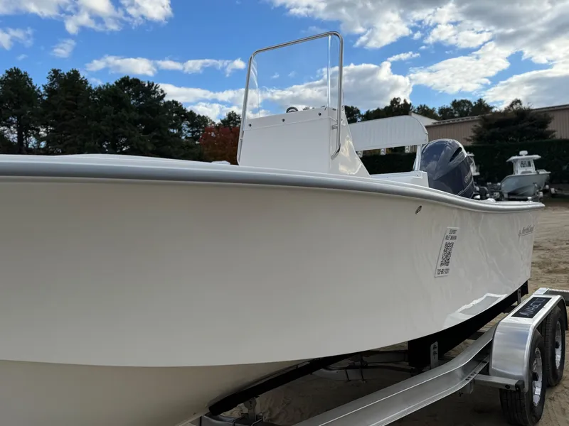 Slide: The Image of 2024 NorthCoast 190 boat on trailer, under a partly cloudy sky. - 11