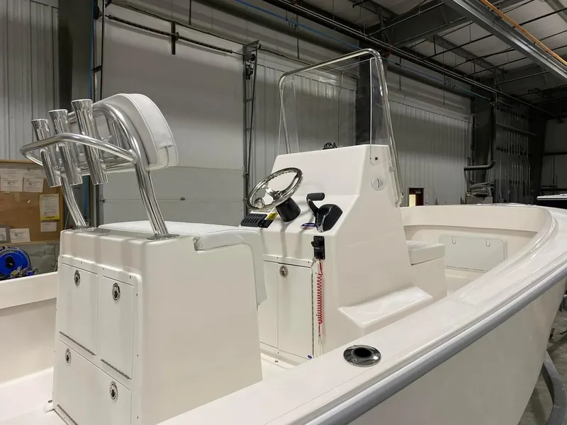 Slide: The Image of 2024 NorthCoast 190 boat interior with steering console in a warehouse. - 3