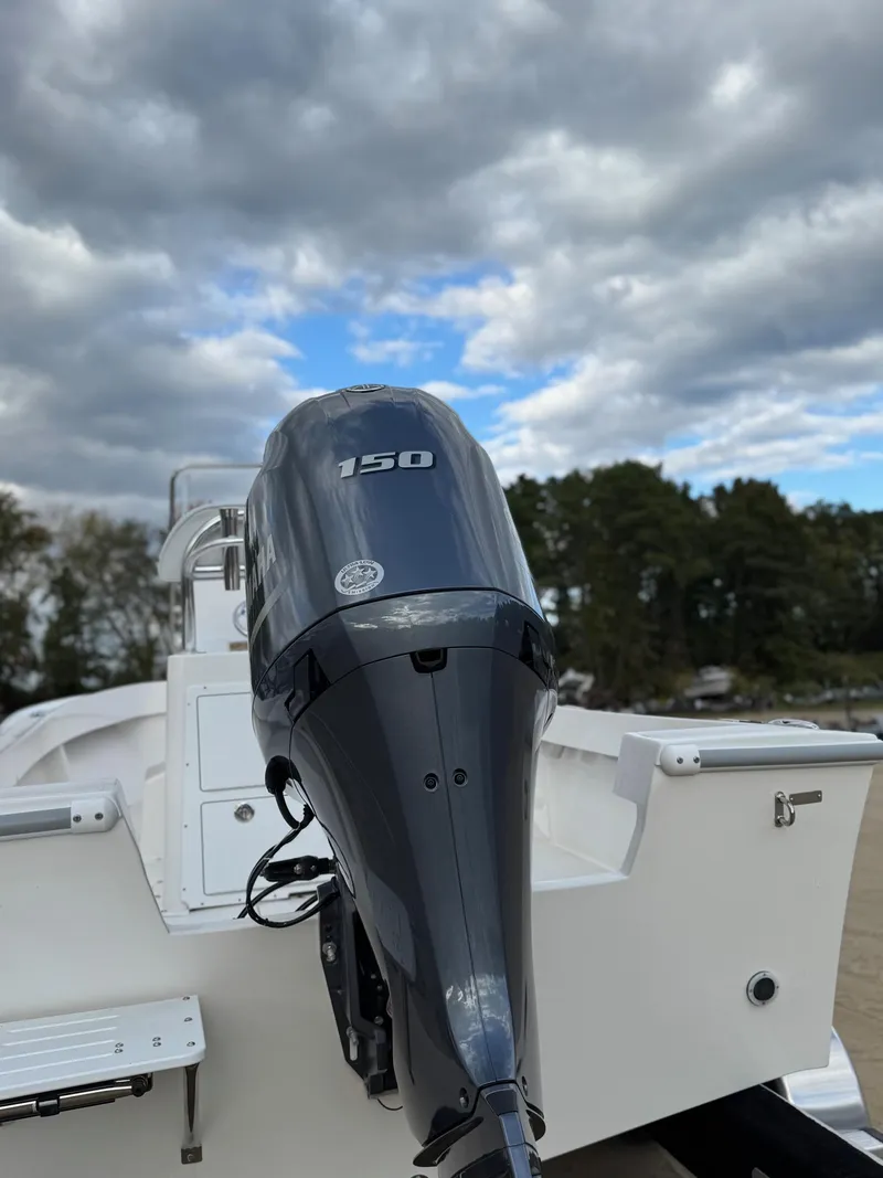 Slide: The Image of 2024 NorthCoast 190 boat with 150 horsepower engine under cloudy sky. - 8