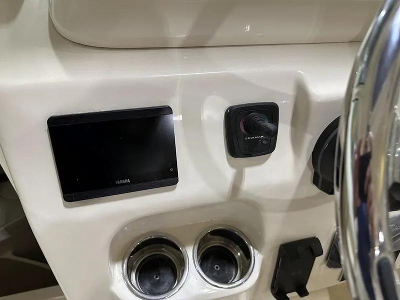Slide: The Image of Control panel of 2024 Grady-White Express 330 boat with electronics and cup holders. - 15