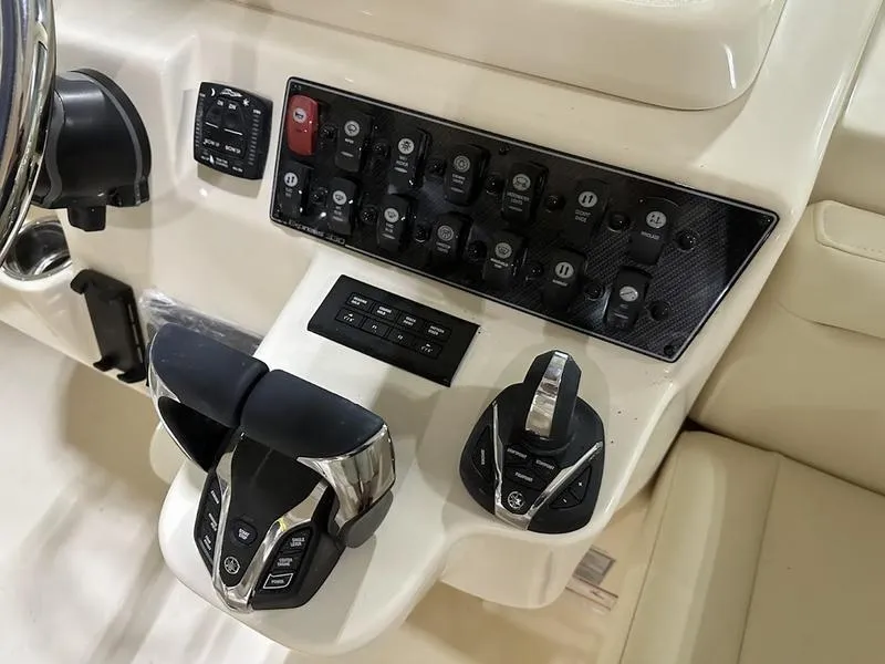 Slide: The Image of Control panel of 2024 Grady-White Express 330 boat with advanced navigation and throttle controls. - 19