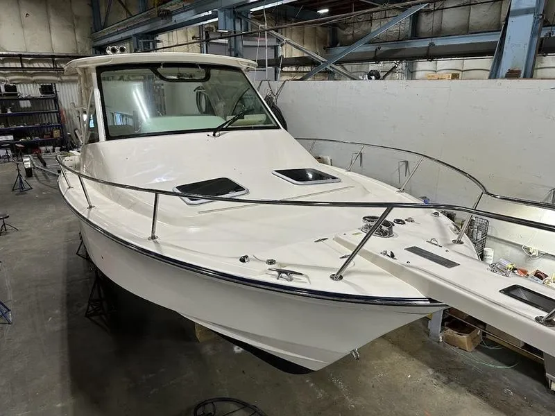 Slide: The Image of 2024 Grady-White Express 330 boat in a warehouse. - 4