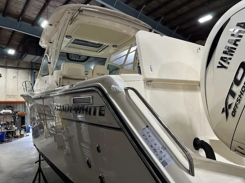 Slide: The Image of 2024 Grady-White Express 330 boat in a warehouse with Yamaha XTO Offshore engine. - 7