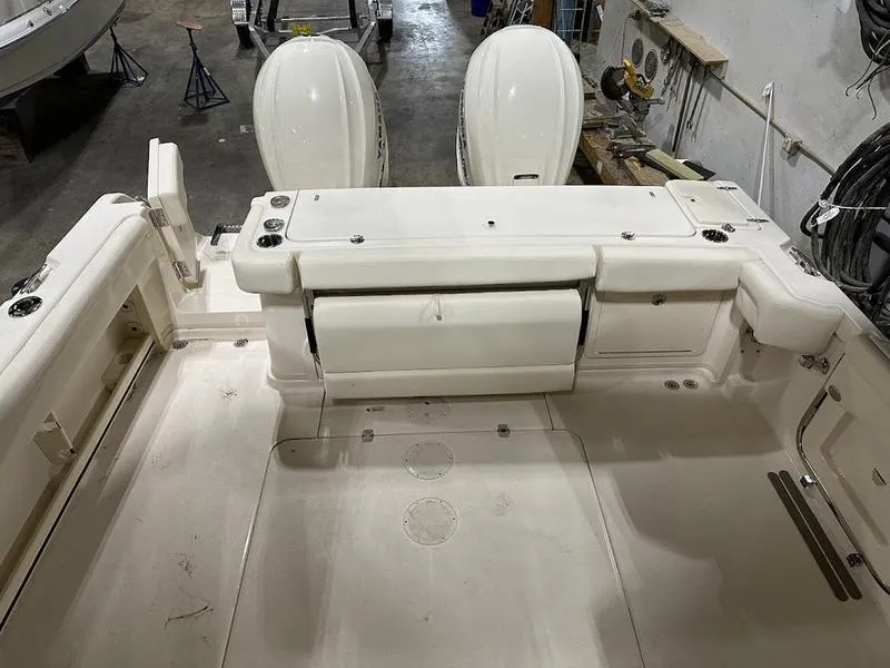 Slide: The Image of 2024 Grady-White Express 330 boat interior with twin outboard engines. - 8