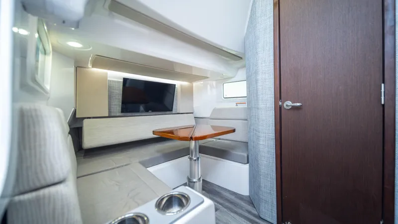 Slide: The Image of Interior of 2023 Everglades 455cc boat with modern seating and TV. - 10