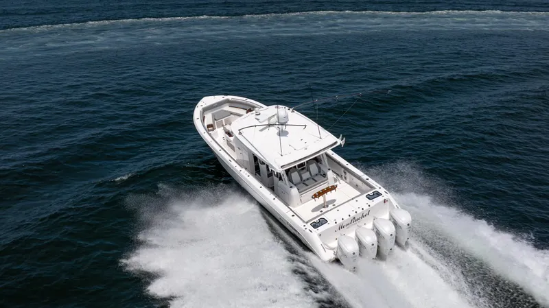 Slide: The Image of 2023 Everglades 455cc boat speeding on open water, showcasing powerful engines. - 15